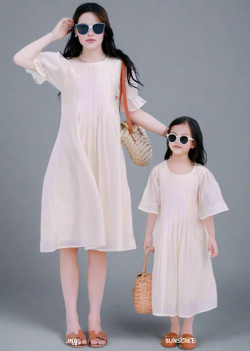 Mother and daughter in matching beige dresses