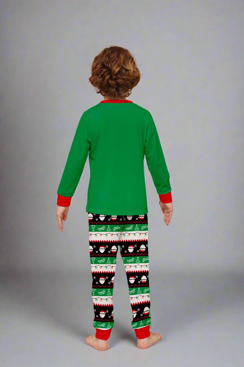 Matching green holiday pajamas with a dabbing Santa design, ideal for family celebrations