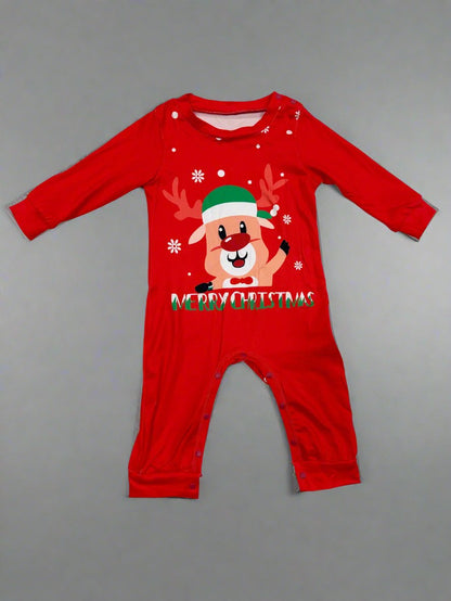 Parents and children in adorable red and green Christmas pajamas with reindeer print, posing by the Christmas tree