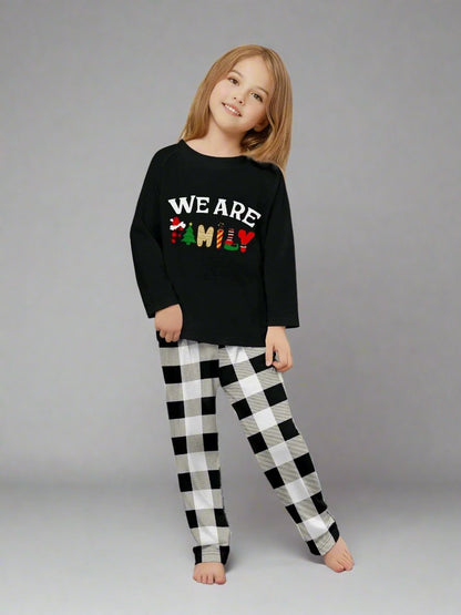 Cozy Christmas pajamas with plaid pants and black tops featuring festive family message