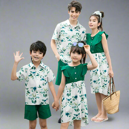 Mother, father, son, and daughter in matching floral outfits in green and white for a stylish family day out