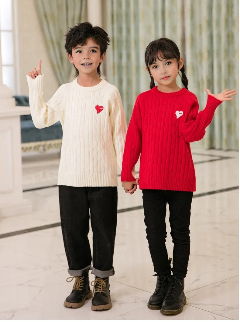 Coordinated family wearing cable knit sweaters in different colors with heart patches, ideal for festive family gatherings