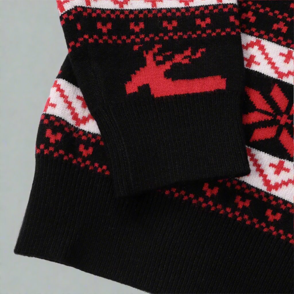 Holiday family outfit featuring black and red matching knit sweaters with a winter reindeer pattern