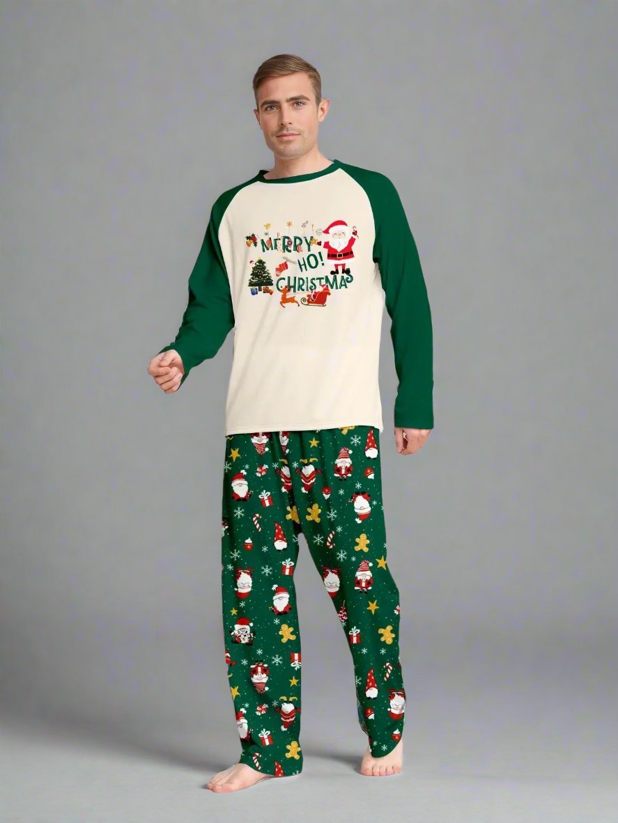 Family dressed in Christmas pajamas with Santa and holiday motifs on green pants for festive photos