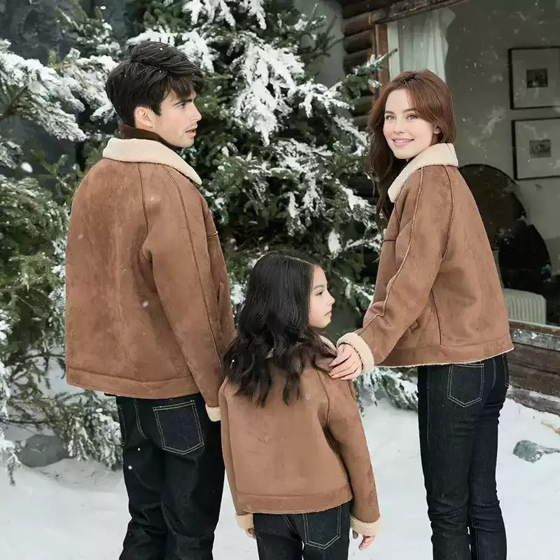 Mom, dad, and child dressed in matching cozy brown shearling jackets and turtlenecks, enjoying a snowy winter day