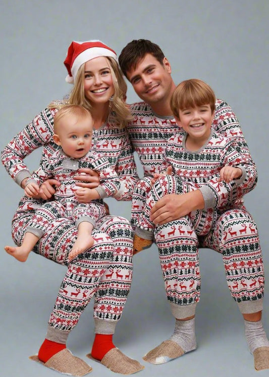 Happy family wearing matching reindeer-themed Christmas pajamas