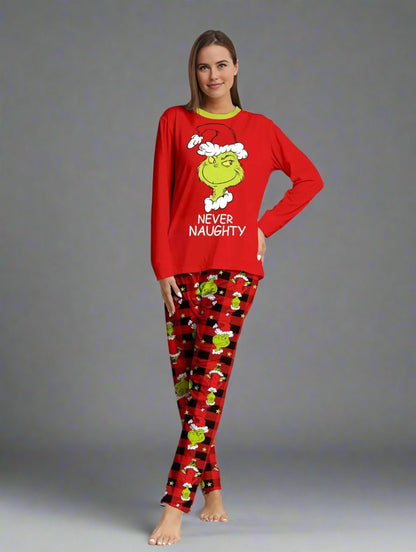 Parents and kids in Grinch Christmas pajamas with fun holiday messages, 'Never Naughty' and 'Behave for the Holiday