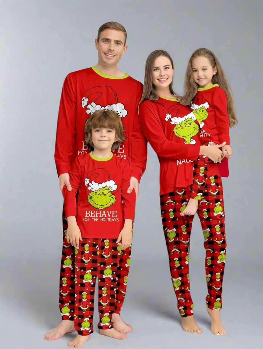 Family wearing matching Grinch Christmas pajamas with 'Behave for the Holidays' and red plaid desig