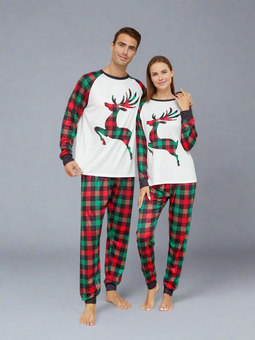 Family wearing matching Christmas pajamas with red and green plaid and reindeer print