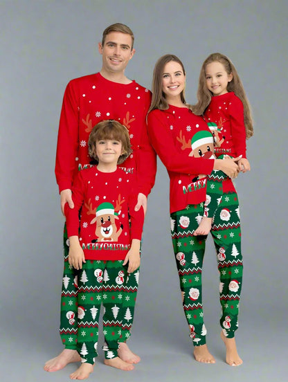 Family wearing matching red and green Christmas pajamas with reindeer print by the Christmas tree