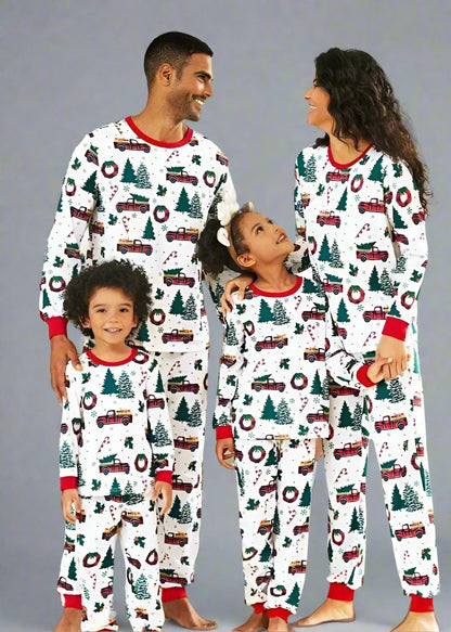 Matching family Christmas pajamas with red truck, tree, and wreath design