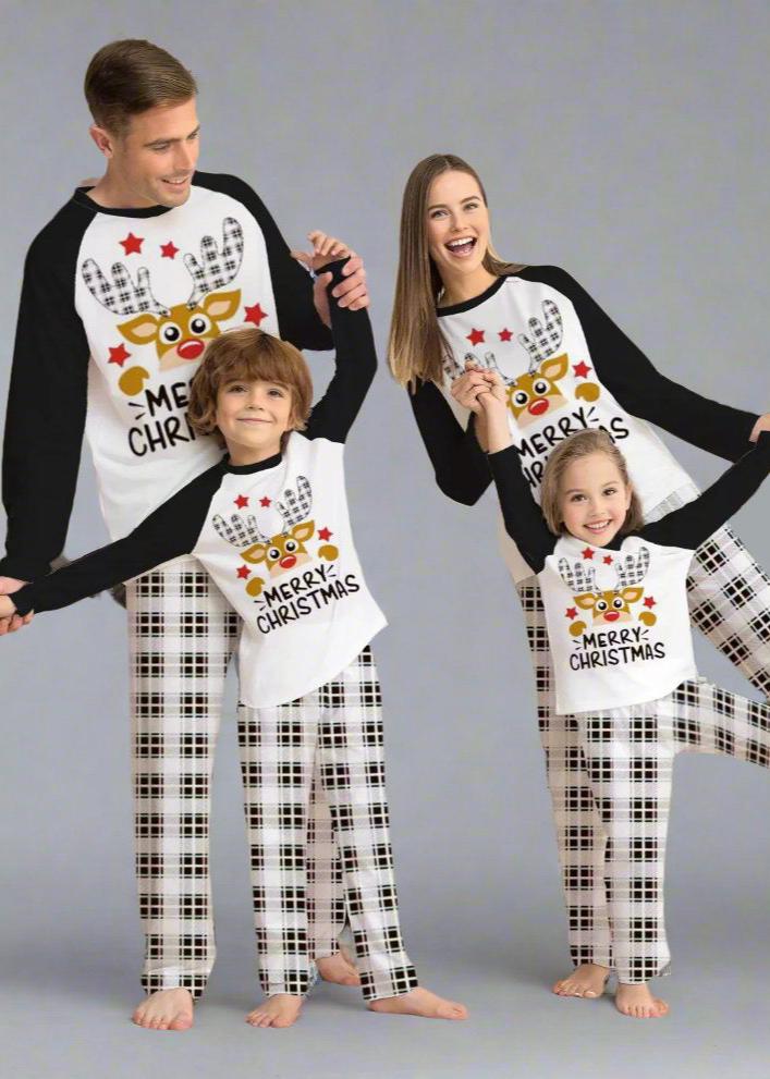 Family in matching plaid Christmas pajamas with reindeer design and 'Merry Christmas' message