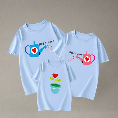 Family matching shirts with 'Mom's Love' and 'Dad's Love' watering can designs and plant for child