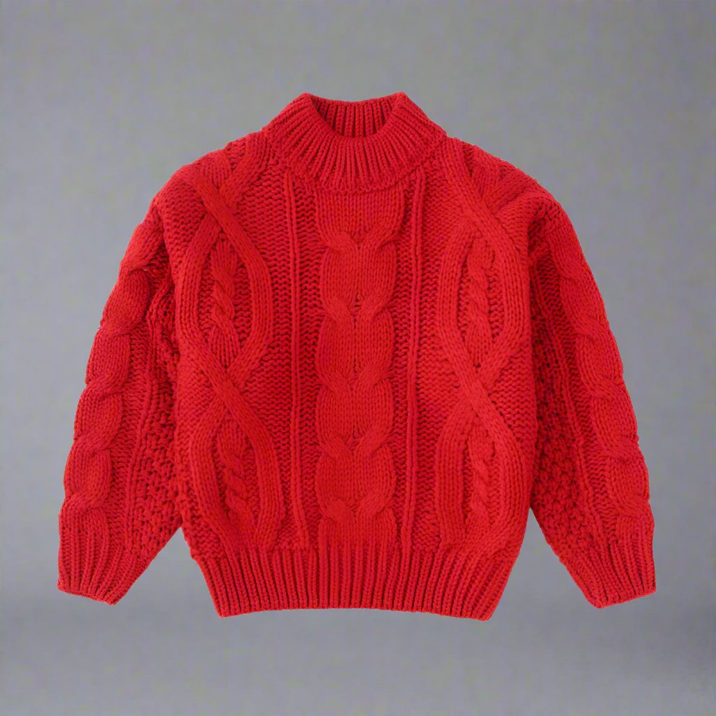 Family dressed in matching red cable-knit sweaters, showcasing a festive holiday look in a warm and stylish setting