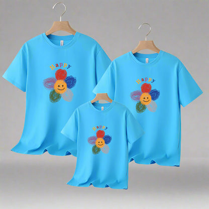 Family matching shirts with smiling flower design, available in multiple colors