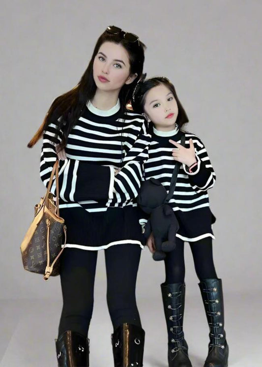 Cozy mother-daughter matching striped black sweaters, perfect for casual outings