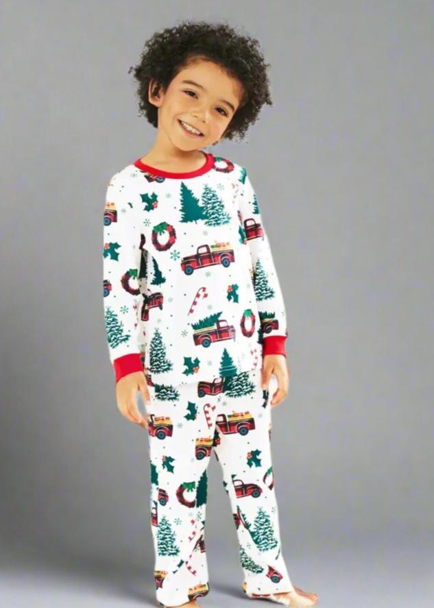 Matching holiday pajamas for family, featuring red truck and Christmas wreath desig