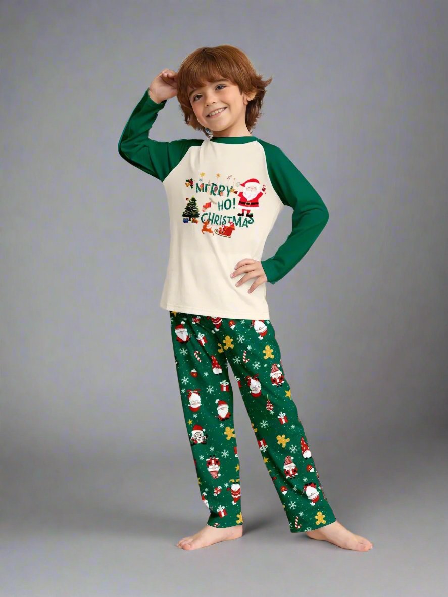 Parents and kids wearing Christmas pajamas with Santa, reindeer, and gift patterns on green pants