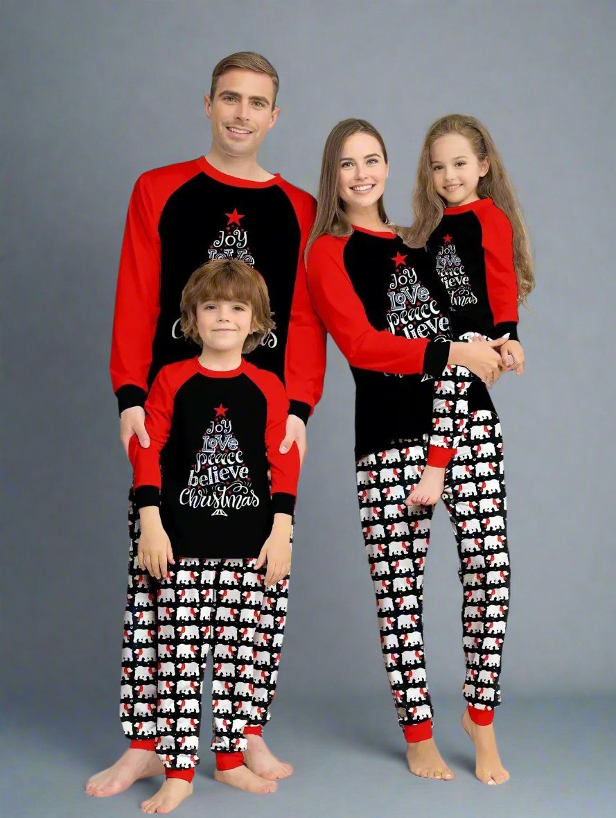 Matching family Christmas pajamas in black and red with 'Joy Love Peace Believe Christmas' text and polar bear print pants