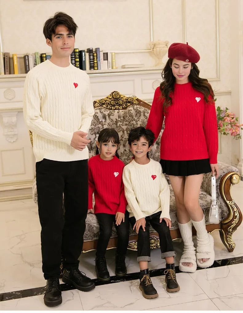 Two kids wearing matching red and white cable knit sweaters with heart patches, ideal for sibling outfits