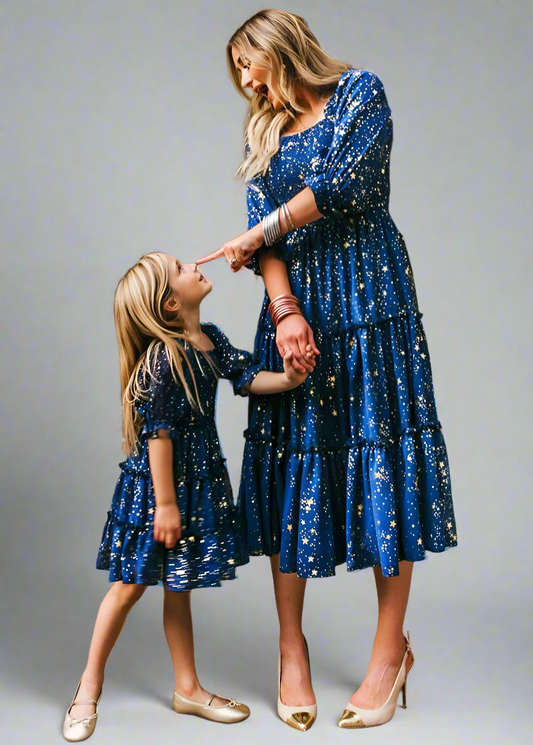 Matching blue starry night dresses for mommy and daughter