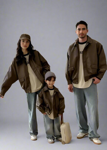 Stylish family in matching brown leather jackets with casual beige shirts and denim jeans, perfect for a trendy fall loo