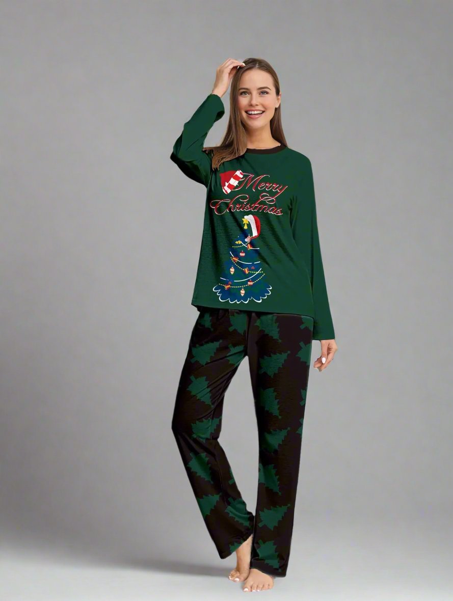 Family in matching green Christmas pajamas with tree pattern and 'Merry Christmas' design