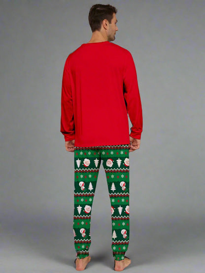 Smiling family in matching reindeer Christmas pajamas with festive green and red colors