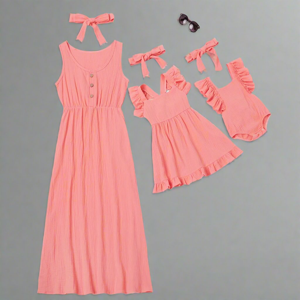 Matching coral dresses for mom, daughter, and baby, perfect for summer.