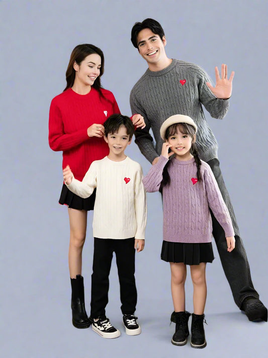 Man and woman wearing matching cable knit sweaters with heart patches in red and grey, perfect for couples