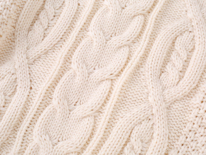 Family in matching cream cable-knit sweaters, creating a warm and stylish winter outfit for family gatherings