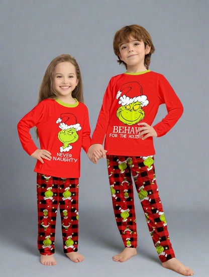 Festive family Christmas pajamas featuring Grinch character with 'Never Naughty' message on red plaid pants