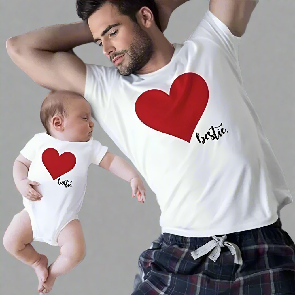 Father and baby in matching shirts with red heart and 'bestie' text, cute family outfit