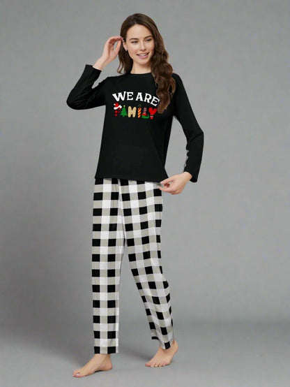 Black and white Christmas pajamas with cheerful 'We Are Family' design, ideal for family gatherings