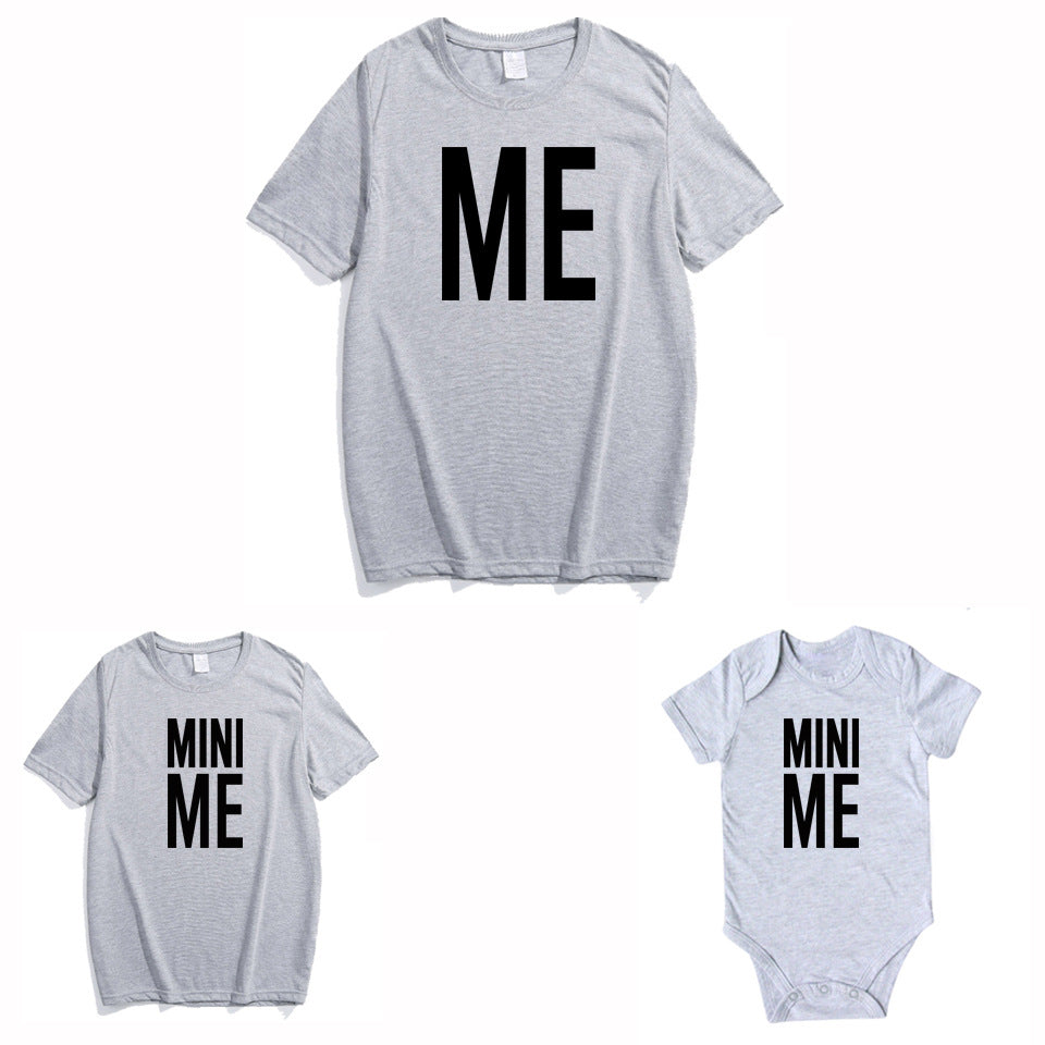 Father in gray 'Me' shirt and toddler in white 'Mini Me' shirt, matching family outfits