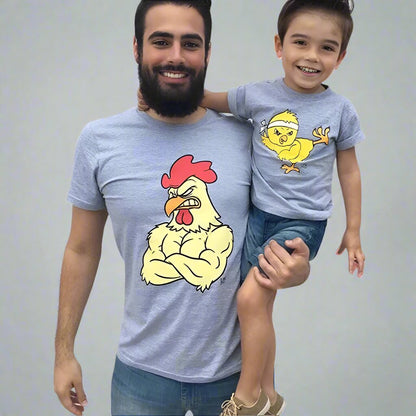 Father and son wearing matching 'muscle chicken' and 'cute chick' graphic shirts in gray