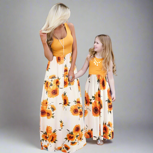 Mother and daughter in matching sunflower print dresses, perfect for summer