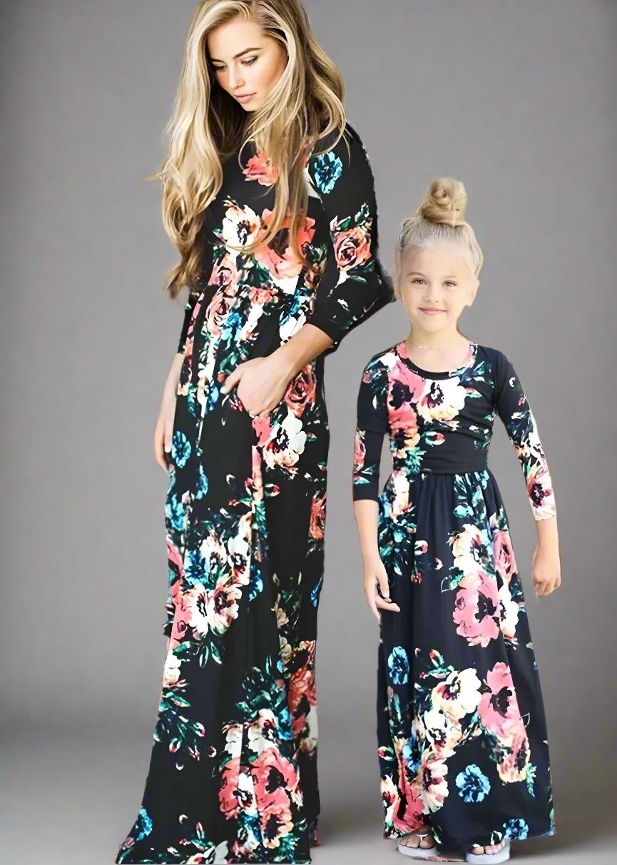 Matching black floral maxi dresses for mom and daughter, designed for a coordinated family look