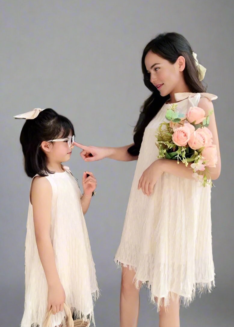 Mommy and daughter wearing matching white dresses for a summer outing