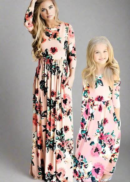 Mom and daughter in matching peach floral maxi dresses, perfect for special occasions