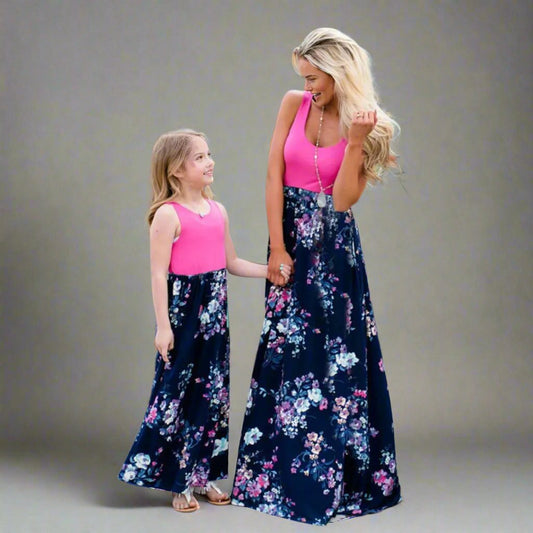 Mommy and me matching pink tank top and floral maxi dresses, perfect for family outings