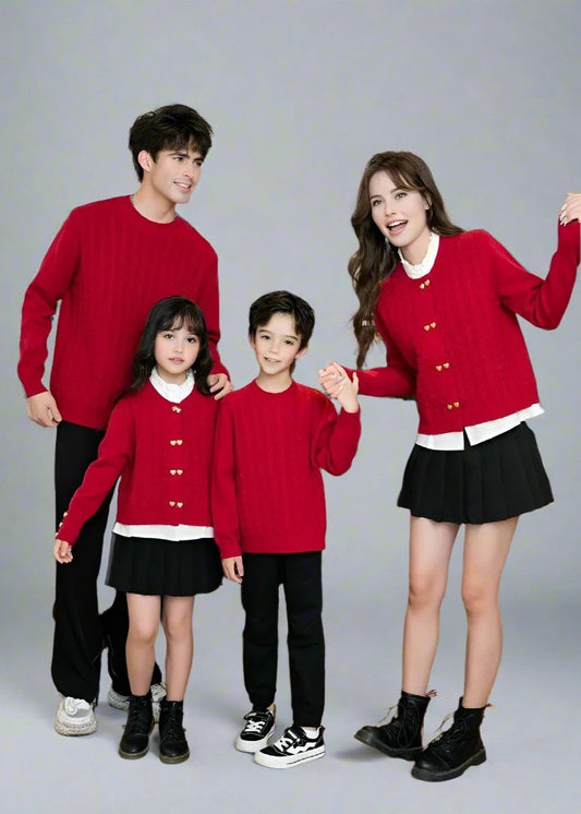 Mother and daughter wearing matching red cable knit cardigans with gold buttons and black skirts, perfect for family outfits