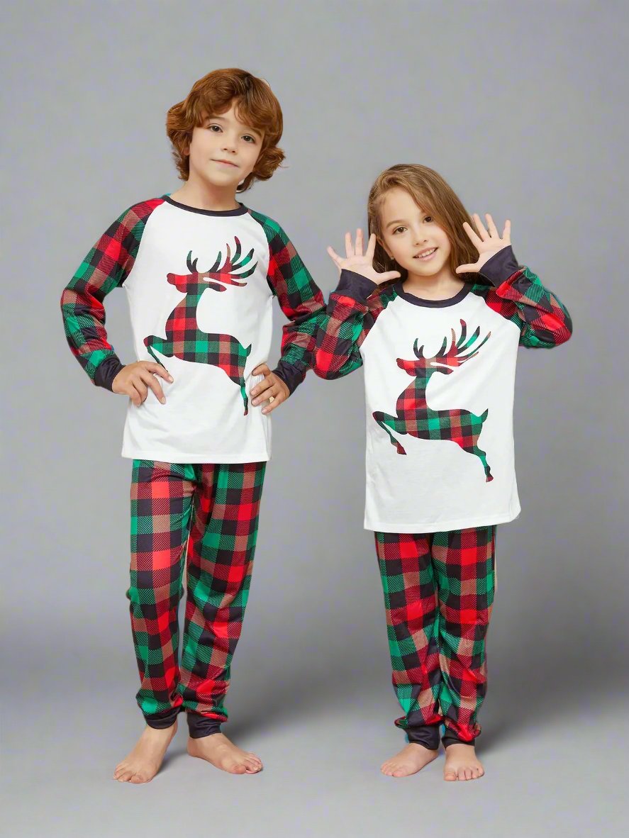 Festive family Christmas pajamas with reindeer design and red-green plaid pattern, ideal for holiday photos