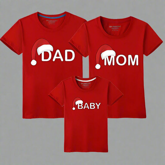 Red matching Christmas t-shirts for families with Santa hat design and 'Dad,' 'Mom,' 'Baby' labels