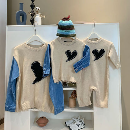 Stylish mom and son in coordinated matching sweaters with denim accents and black heart details, perfect for fall street fashion