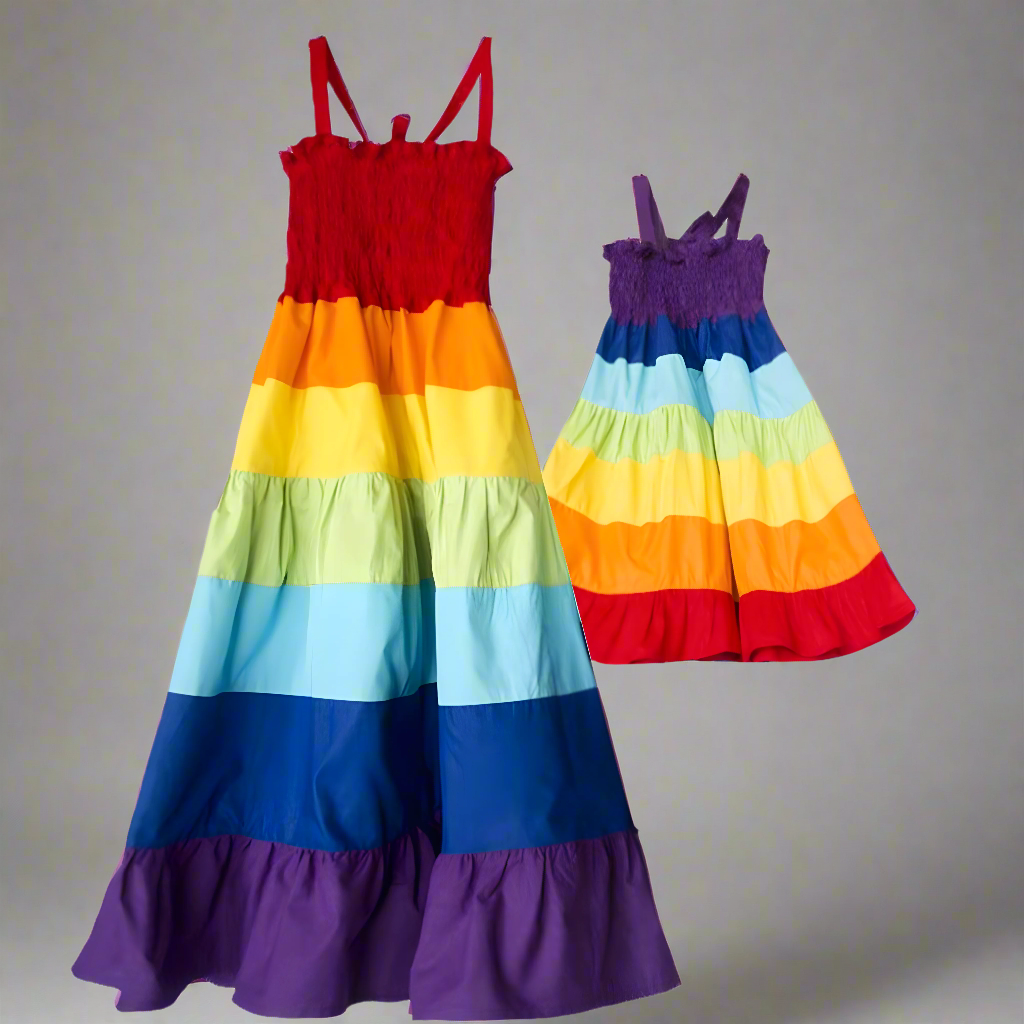 Mom and daughter in matching rainbow dresses with tiered layers, showing a fun summer styl