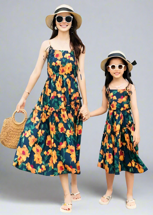 Mommy and daughter in tropical floral matching dresses at the beach