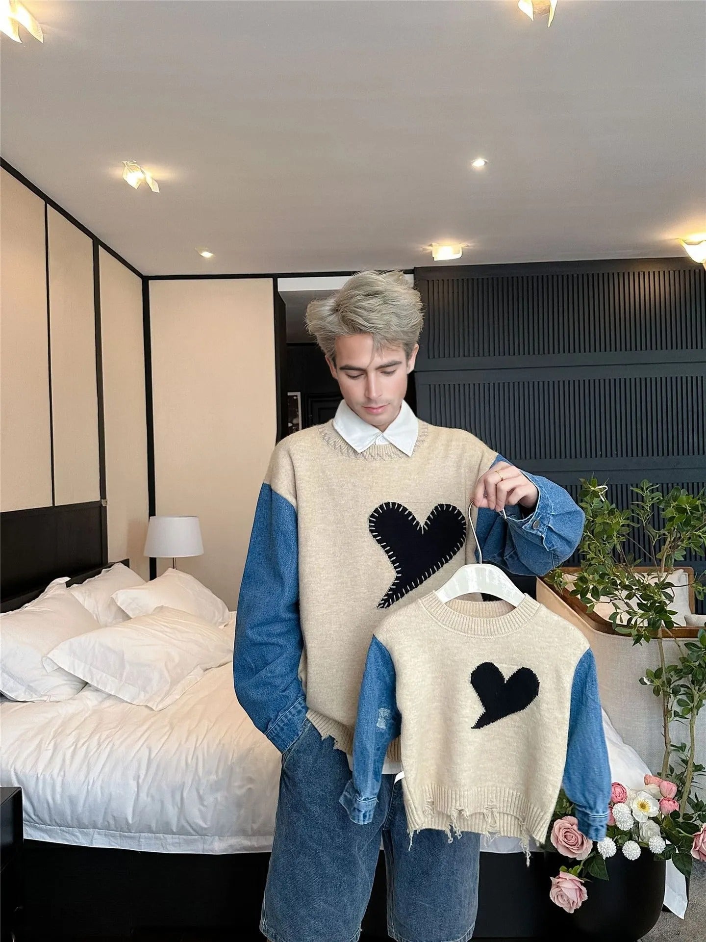 Urban matching outfits for mom and kid featuring oversized sweaters with heart patterns and denim, styled for a city walk