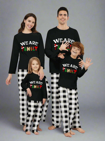 Matching Christmas pajama set with 'We Are Family' design and black plaid pants for parents